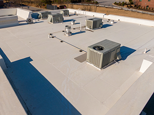 TPO-Roofing-Beavercreek-OH-Ohio-2 | A.H. Sturgill Roofing Rooftop with several outdoor air conditioning units and vents on a bright white flat roof under a sunny sky.